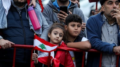 A child holds a Lebanese flag on the day Pope Leo arrives in Lebanon. Rueters