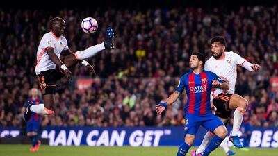 Valencia’s Eliaquim Mangala, left, controls the ball next to his teammate Ezequiel Garay. Alex Caparros / Getty Images