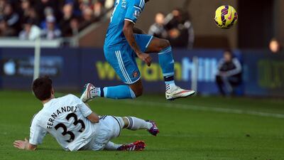Sunderland defender Patrick van Aanholt, top, is tackled by Swansea City defender Federico Fernandez during their English Premier League match at The Liberty Stadium in Swansea, Wales, on February 7, 2015. Geoff Caddick / AFP