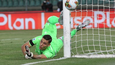 Verona goalkeeper Marco Silvestri makes a diving save. AP Photo