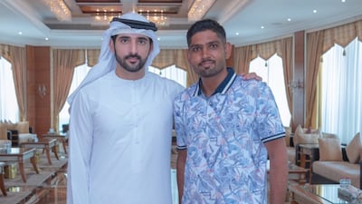 Sheikh Hamdan with Abdul Ghafoor Abdul Hakim. Mr Hakim, who is from Pakistan, said he was only carrying out his duty to protect fellow road users. Photo: Sheikh Hamdan / Twitter