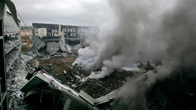 Plumes of smoke rise as firefighters work at the scene after a car bomb exploded in a parking lot at Madrid's new airport terminal in December 2006. Bernat Armangue/ AP Photo