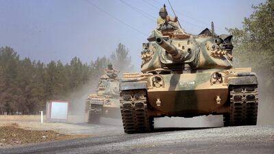 Turkish tanks head towards the Syrian border, in Karkamis, on August 31, 2016. Ismail Coskun, IHA via AP