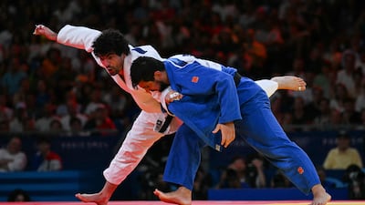 Greece's Theodoros Tselidis and UAE's Aram Grigorian in action. AFP