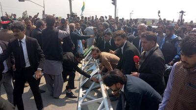 Supporters of former prime minister Imran Khan gather near a court where Khan is set to appear, Islamabad, Pakistan, 18 March 2023. Khan is set to make a court appearance for proceedings of the complaint filed by the Election Commission of Pakistan (ECP) for his alleged concealment of gifts in assets declarations, few days following clashes that erupted between supporters and police forces attempting to arrest him after repeatedly failing to show up in court. EPA / SOHAIL SHAHZAD