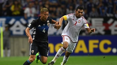 Walid Abbas of UAE, right, and Keisuke Honda of Japan compete for the ball during their World Cup qualifier at Saitama Stadium on September 1. Etsuo Hara / Getty Images