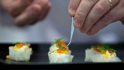 French chef Bruno Menard prepares a Singapore crab siew mai in a step-by-step presentation during a Gourmet Abu Dhabi masterclass at the Armed Officers Club. Silvia Razgova / The National