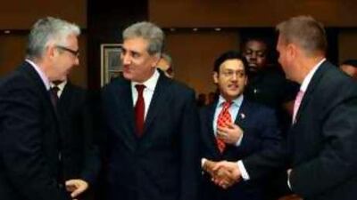 Shah Mahmoud Qureshi, Pakistan's foreign minister, second left, and Javed Malik, Pakistan's ambassador at large, right, meet guests at the forum, held at Grosvenor House.
