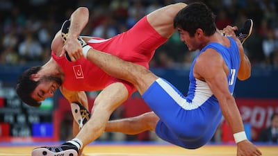 LONDON, ENGLAND - AUGUST 12: Ramazan Sahin of Turkey in action against Ikhtiyor Navruzov of Uzbekistan during the Men's Freestyle 66 kg Wrestling repechage fight on Day 16 of the London 2012 Olympic Games at ExCeL on August 12, 2012 in London, England. (Photo by Ryan Pierse/Getty Images) *** Local Caption *** 150204059.jpg