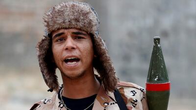 A fighter loyal to the GNA shouts to a comrade during the clash. Reuters