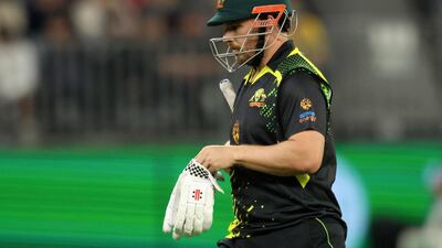 Australia's Aaron Finch walks back to the pavilion after being run out for 12. AFP