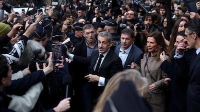 Former French president Nicolas Sarkozy arrives at a Paris bookshop to sign copies of his memoir recounting his time in prison. Reuters