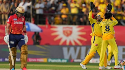 Chennai Super Kings' MS Dhoni, centre, and teammate' Ravindra Jadeja celebrate the wicket of Punjab Kings' captain Sam Curran. AP