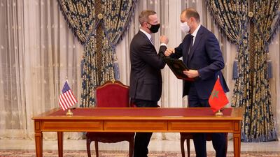 Unidentified officials greet each other at the signing of memorandums of understanding during a visit by Israeli envoys to Rabat, Morocco. REUTERS