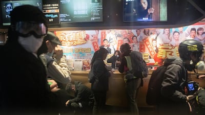 People react in a cinema after riot police deploy tear gas on Portland Street during a protest in the Mong Kok district of Hong Kong, China. Bloomberg
