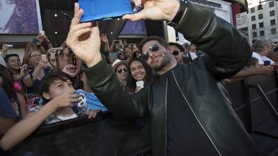 Cast member Bradley Cooper takes a selfie with fans at the premiere of Guardians of the Galaxy in Hollywood, California on July 21, 2014. The movie opens in the US on August 1. Mario Anzuoni / Reuters