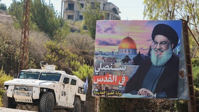 A UN peacekeepers vehicle drives near a picture showing Lebanon's Hezbollah leader Hassan Nasrallah in Adaisseh village, near the Lebanese-Israeli border, in southern Lebanon. Reuters