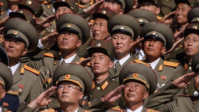 Korean People's Army (KPA) soldiers salute as they watch a mass rally on Kim Il Sung square in Pyongyang. AFP
