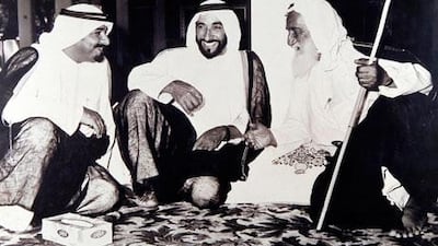 Sheikh Rashid, right, with Sheikh Zayed bin Sultan, centre, and his son, the current Ruler of Ajman, Sheikh Humaid bin Rashid.