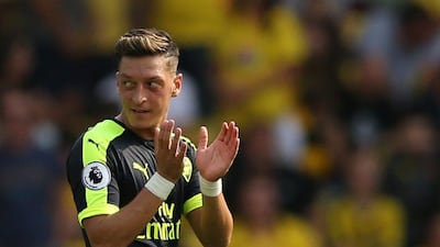 Arsenal's Mesut Ozil celebrates scoring their third goal against Watford on Saturday. Andrew Boyers / Reuters