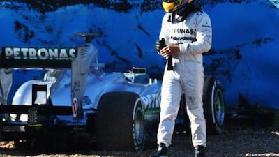 Lewis Hamilton walks away from his new Mercedes GP car after crashing into a tire wall during his first day's testing in Jerez.