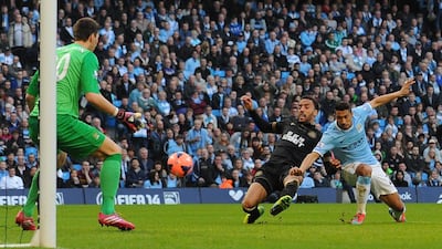 Wigan Athletic's James Perch, centre, scores his team's second goal past Manchester City's Romanian goalkeeper Costel Pantilimon, left, in Wigan's 2-1 win on March 9, 2014, to advance to the English FA Cup final at Wembley. Andrew Yates / AFP