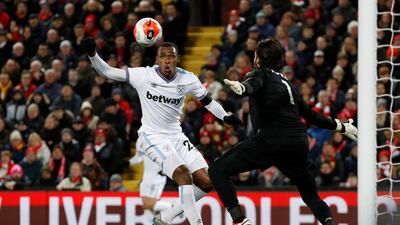 West Ham United's Issa Diop in action with Liverpool's Alisson. Reuters