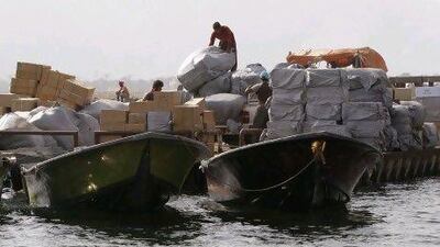 Iranian smugglers load goods at the Omani port of Khasab. Until recently the Iranian boats and their young skippers escorted several cargoes a day across the narrow Strait of Hormuz.