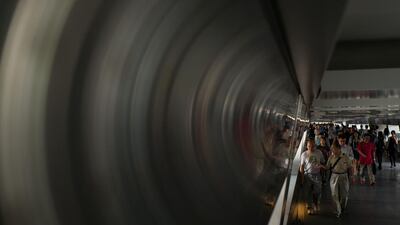 Pedestrians walk along a footbridge connecting buildings in Hong Kong. Anthony Wallace / AFP