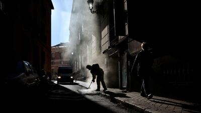 A worker mends a pavement in central Madrid. Andrea Comas / Reuters