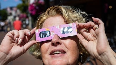 A woman wears eclipse glasses in Almelo, the Netherlands. EPA
