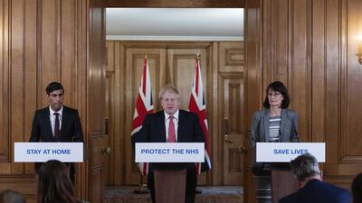 UK Prime Minister Boris Johnson, centre, speaks while Chancellor of the Exchequer Rishi Sunak, left, and deputy chief medical officer Jenny Harries, right, listen during a daily coronavirus briefing at 10 Downing Street, on March 20, 2020. Bloomberg