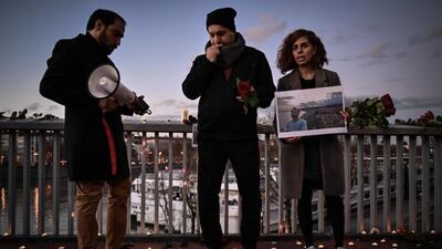 A woman holds a picture of Mohammad Moradi, an Iranian who killed himself after jumping into the Rhone river. AFP