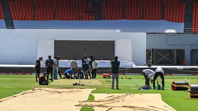 Groundsmen work on the pitch ahead of the fourth Test. AFP