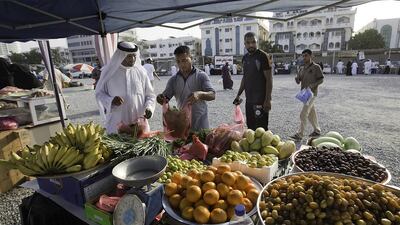 A resident stocks up with greens at a stall offering traditional fruits and vegetables at the Ramadan food carnival in Fujairah. Jaime Puebla / The National
