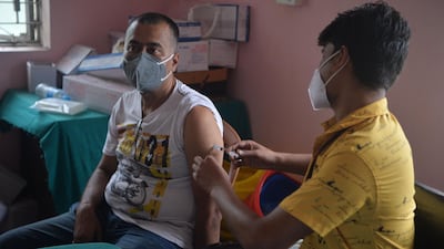 A man is inoculated against Covid-19 in Siliguri, West Bengal. India is seeking to significantly increase its vaccination rate. AFP