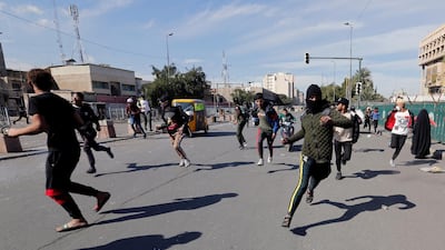 Iraqi demonstrators run away from security forces during the ongoing anti-government protests in Baghdad. REUTERS