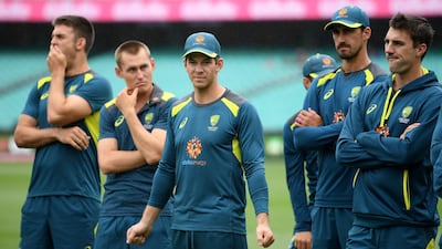 Australia's captain Tim Paine, centre, watches on with teammates as India celebrate a 2-1 series victory following play being abandoned on Day 5 in the fourth Test match in Sydney. Reuters