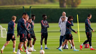 Arsenal players take part in training. PA