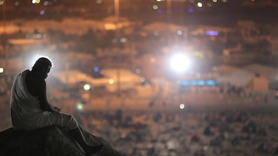 A Muslim pilgrim prays on a rocky hill called the Mountain of Mercy, on the Plain of Arafat, near the holy city of Mecca, Saudi Arabia. Mosa'ab Elshamy / AP Photo