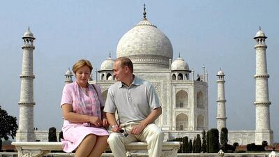 Russian President Vladimir Putin speaks to his wife Ludmila as they pose in front of the Taj Mahal on October 4, 2000. AFP