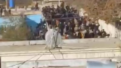 People gather on a roof of a building in Kabul, Afghanistan in this still image obtained from a video. REUTERS