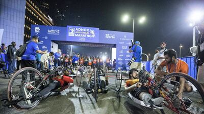 Paraathletes in a wheelchair participating in the marathon at the Adnoc Abu Dhabi Marathon. Leslie Pableo for The National