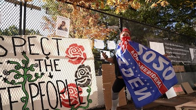 Jordan Johnson poses with a Biden flag outside the White House, in Washington. Reuters