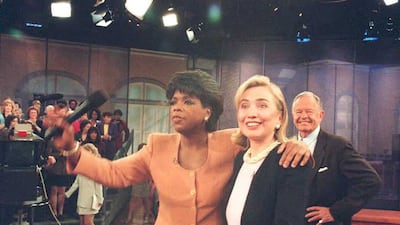 Oprah Winfrey wears an orange jacket during a segment on the 'The Oprah Winfrey Show' with Hillary Clinton in Chicago, Illinois on May 16, 1995. AFP
