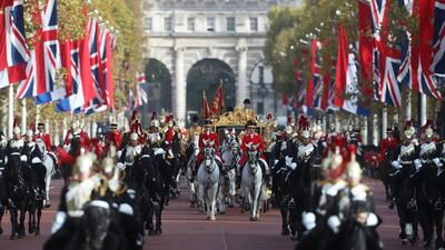 Britain's Queen Elizabeth and King Willem-Alexander of the Netherlands ride the State Coach along the Mall in London. Simon Dawson / Reuters