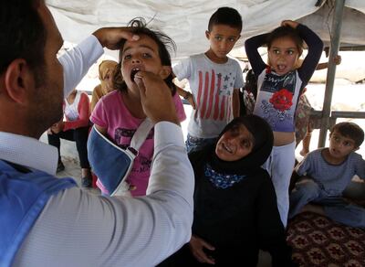 Palestinian children receive a medical check up from a UNRWA team on the outskirts of Hebron. AFP