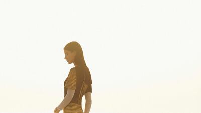 Black and gold tweed dress; ecru dress in fine jersey (worn underneath); and cuff bracelets in gold metal, all from Chanel.