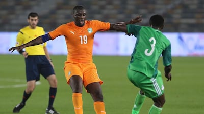 Ivory Coast midfielder Yaya Toure, left, controls the ball under pressure from Nigeria’s Chima Akas during their friendly at Zayed Sports City on Sunday January 11, 2015. The Ivory Coast won 1-0, with Salomon Kalou scoring the deciding goal in the 83rd minute. Wilfried Bony was not in the Ivory Coast squad as he awaited confirmation of his move from Swansea City to Manchester City. AFP