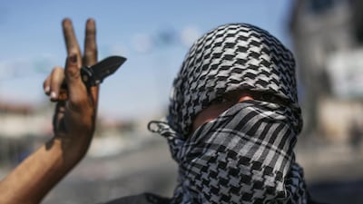 A Palestinian holds a knife near the home of slain 16 year-old Palestinian Mohammed Abu Khdeir, at the East Jerusalem neighborhood of Shuafat, 05 July 2014. Clashes erupted between police and protesters in East Jerusalem and in Arab villages in northern Israel, as Palestinians said a slain teenager was burned alive this week. Police are investigating whether his death was carried out by Israelis in revenge for the abduction and killing of three Jewish teens the month before. Atef Safadi / EPA